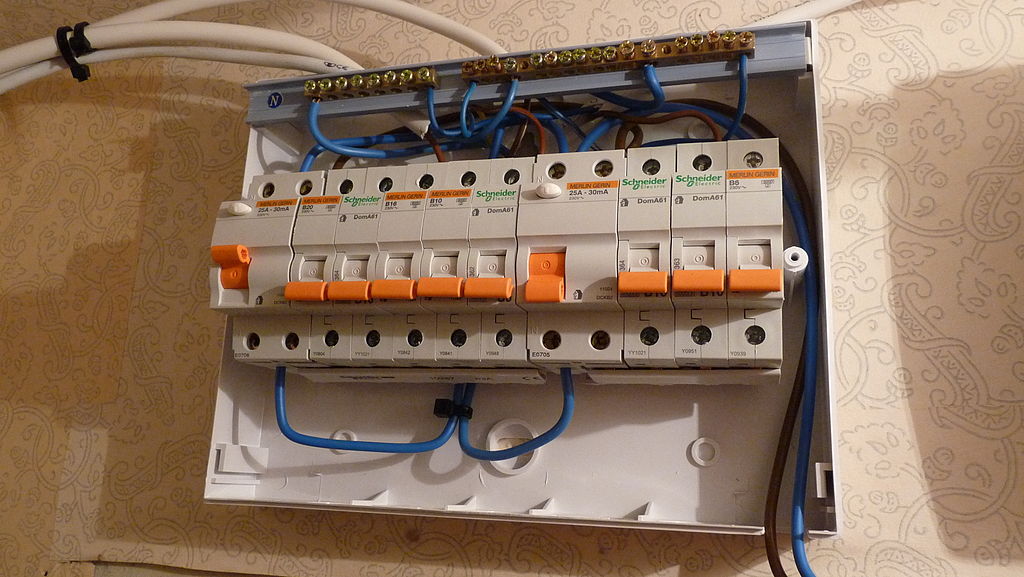 A consumer unit with its cover off, showing the breakers and wiring